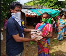 Volunteers distributing ration packets in a village
